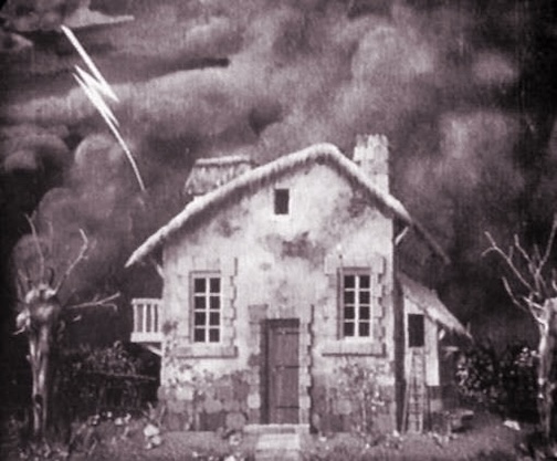 A black and white image of a spooky, old farmhouse during a lightning storm.
