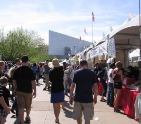 A festival at The Square PHX with the Science Center in the background.