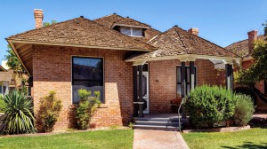 Stevens-Haustgen House at The Square, an early 19th century, single-story brick home with a wooden shingle roof.
