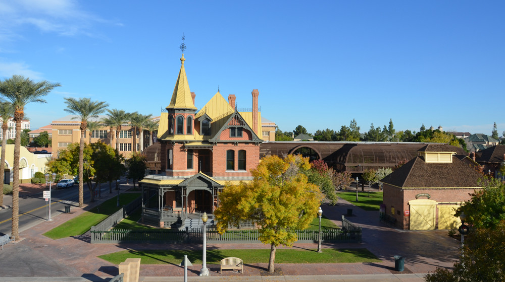 A picture of Rosson House Museum and the Visitor Center Carriage House under a bright blue sky.