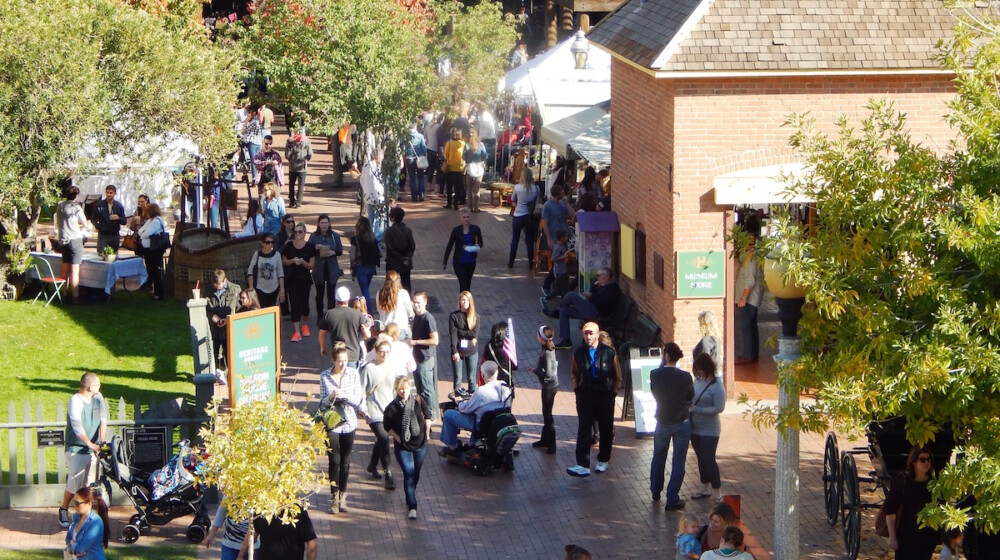 A busy festival at The Square PHX, surrounding the Visitor Center.