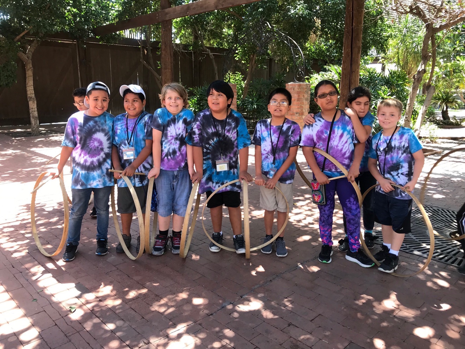 A picture of a group of students posing with 19th century lawn games.