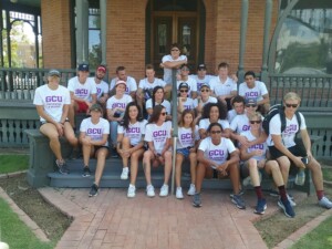 A large group of volunteers from Grand Canyon University posing on the steps of Rosson House after their day of volunteering.