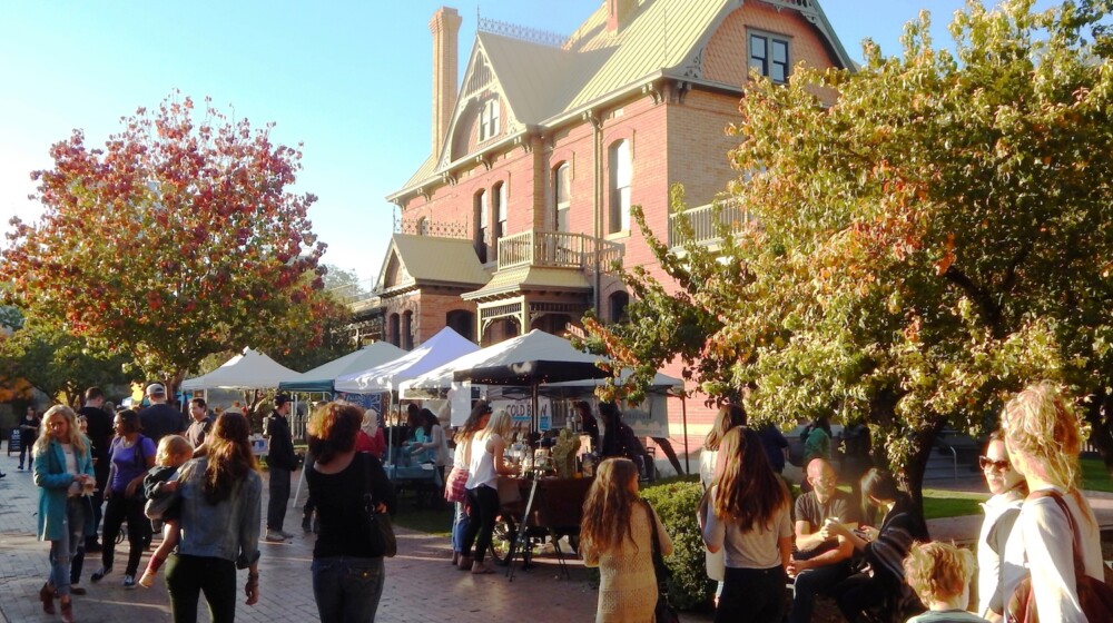 A festival with tents at The Square PHX, with Rosson House in the background.