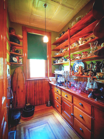 The Rosson House pantry, filled with many ornate, Victorian Era dishes.