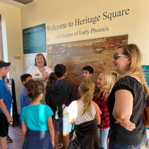 A picture of several students and their chaperone listening to a The Square PHX staff member as they start their field trip at The Square PHX.