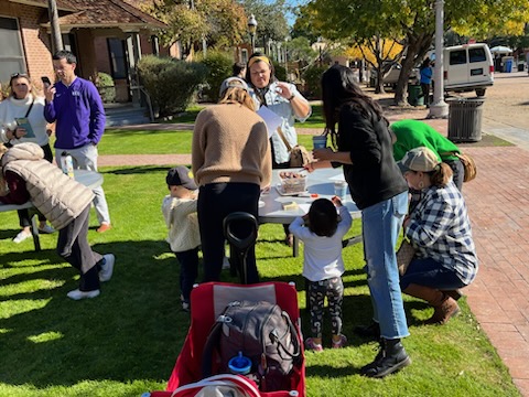 A picture of families doing crafts and activities on the front lawn of the Museum Store at The Square PHX.