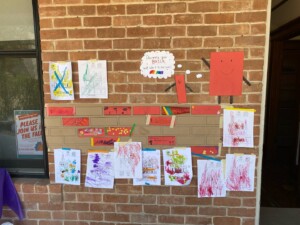 A picture of a kids' craft set up in front of a brick wall.