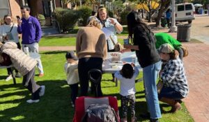 A picture of families doing crafts on the lawn at The Square PHX.
