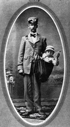 A black and white photo of a mailman with a baby in his mail pouch, circa 1913.