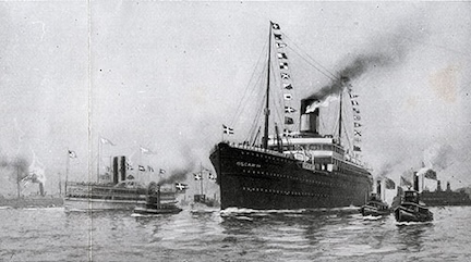 An old, black and white photo of a steamer ship in a harbor with several smaller ships around it.