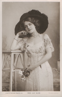 An old, black and white image of a woman from the early 1900s wearing a very large hat.